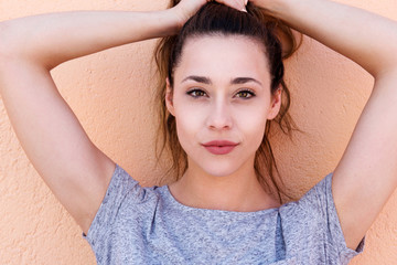 Wall Mural - young beautiful woman holding hair above head