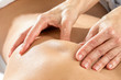 Detail of hands massaging shoulder blade.