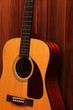 © blackguitar1 - Acoustic guitar on a wooden background.