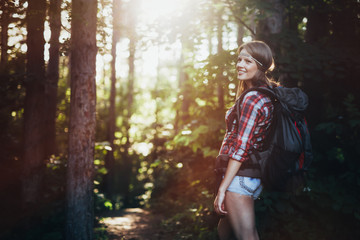 Wall Mural - female backpacker set out on forest trail