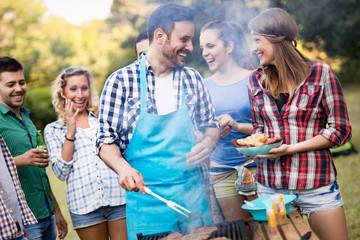 Wall Mural - Happy friends enjoying barbecue party