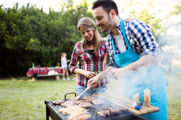 Happy outgoing people enjoying bbq