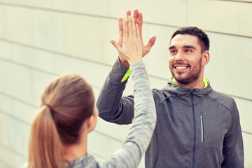 Canvas Print - happy couple giving high five outdoors