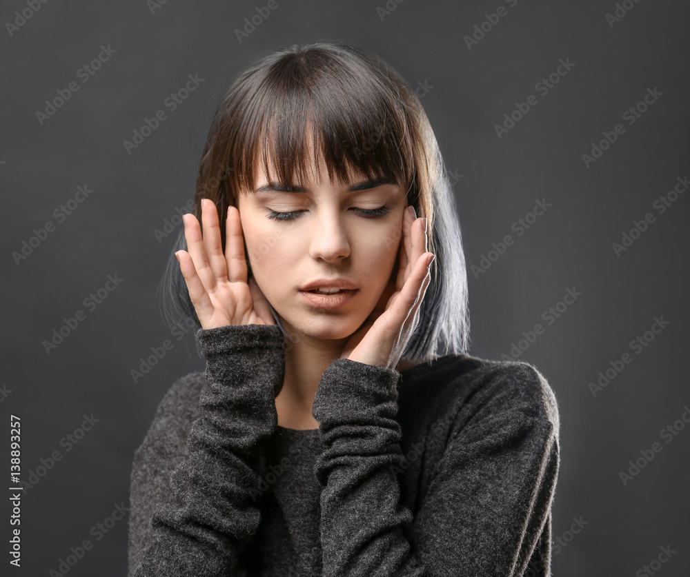 Beautiful young woman on dark background