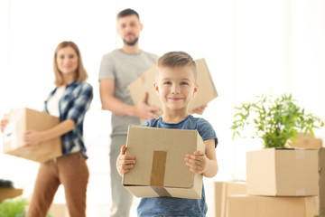 Wall Mural - Happy boy with box on blurred background. Moving concept