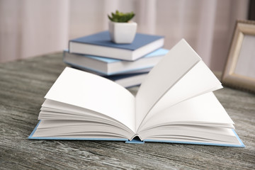 Wall Mural - Open book on wooden table