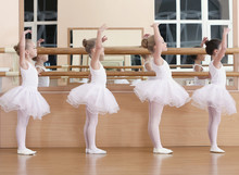Group Of Beautiful Little Girls Practicing Ballet At Class