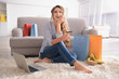 © Africa Studio - Young woman shopping online with credit card and laptop at home