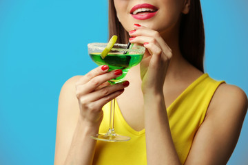 Poster - Young beautiful woman with tasty cocktail on light background