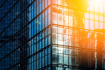 Modern office building detail, glass surface with sunlight