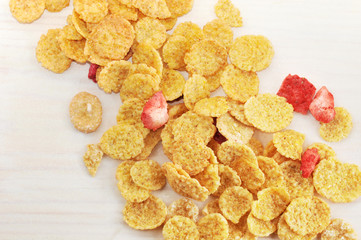 Wall Mural - background of corn flakes with slices of strawberries