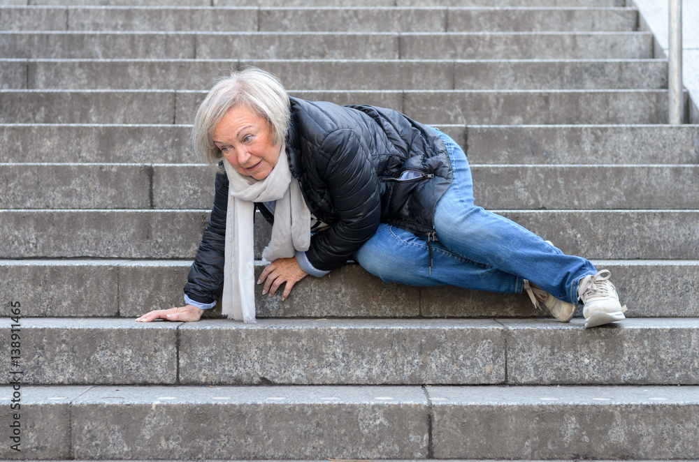 Senior woman falling down stone steps outdoors - obrazy, fototapety, plakaty 