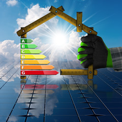 Wall Mural - Energy Efficiency - Wooden ruler in the shape of house with Solar Panels