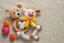 Knitted Rattles For Toddlers And Copy Space. Perfect Background For Childhood Theme. Cow And Bear Toys.