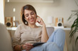 © chika_milan - woman reading / listening music using tablet at home