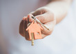 © natara - Female hand holding house key,real estate agent.