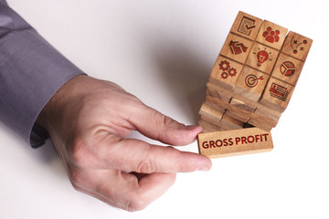 Business, Technology, Internet and network concept. Young businessman shows the word: Gross profit