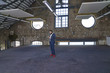 © Westend61 - Businessman standing in a loft using cell phone