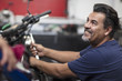 © Westend61 - Smiling mechanic working on motorcycle in workshop