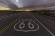 © trekandphoto - Historic Route 66 highway pavement sign late at night in the California Mojave desert.