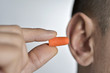© nito - man putting on an earplug