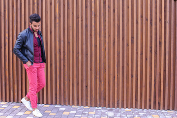 Wall Mural - Young handsome guy Arabic standing in full growth and poses, loo