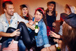 © pressmaster - Group of trendy young people getting drunk at late night swag party, going crazy and laughing while sitting on sofa with beer bottles