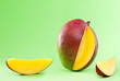 © Valerii Dekhtiarenko - mango and mango slices isolated on a green background