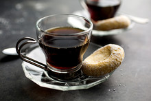Cup Of Black Coffee With Moroccan Semolina And Almond Cookie On Saucer