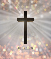 Wall Mural - Jesus Christ cross. Christian wooden cross with He is risen text on background with colorful orange,yellow blurry lights,sunbeams,sunlight glowing behind the cross. Easter, resurrection concept,card
