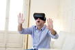 © Wordley Calvo Stock - happy man at home living room sofa couch excited using 3d goggles watching 360 virtual reality