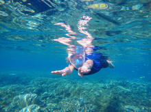 Woman Swimming Underwater In Swimming Costume And Full-face Mask
