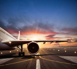 Wall Mural - Close-up of airplane on runway in sunset light