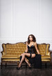 © Acronym - Sexy and beautiful woman in erotic lingerie and stockings posing on a sofa in vintage interior.