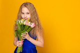 Fototapeta Tulipany - Beautiful girl with a bouquet of tulips