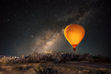 Hot Air Balloon Flying Over Spectacular Cappadocia Under The Sky With Milky Way And Shininng Star At Night
