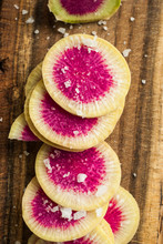 Watermelon Radishes Sliced, Sprinkled With Sea Salt On A Wooden Background
