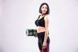 © dianagrytsku - Attractive beautiful young sportswoman holding yoga mat