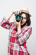 © dianagrytsku - Woman traveler taking picture with camera on grey background