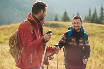 Hikers talking together while trekking in the wilderness