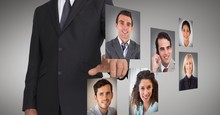 Businessman Touching Profile Pictures Of Business Executives