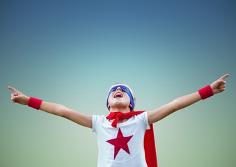 Wall Mural - Boy pretending to be a superhero against blue background