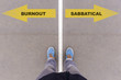 Burnout or sabbatical text on asphalt ground, feet and shoes on floor