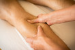 © monika - Therapist applying pressure on male leg - hand massage of human calf muscle