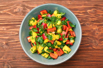 Wall Mural - Mango salad with pepper and parsley in a bowl