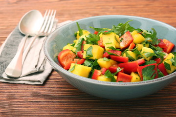 Wall Mural - Mango salad with pepper and parsley in a bowl
