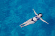 © tmelnikova - Active senior woman swimming in blue sea water