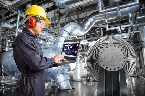 Fotografie, Obraz Engineer using laptop computer in thermal power plant factory
