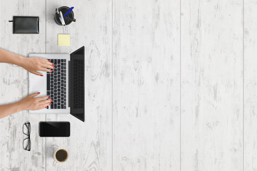 Leinwandbilder - Modern laptop and mobile phone on office desk with free space for text. White wooden texture in background.