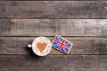 british flag shaped cookie and cup of coffee on the wonderful brown wooden background